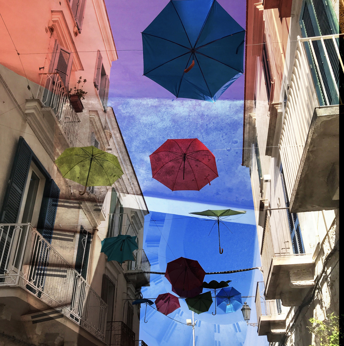 Hallucinations: Trani Puglia with Umbrellas Red and Blue by Bonnie Levinson 