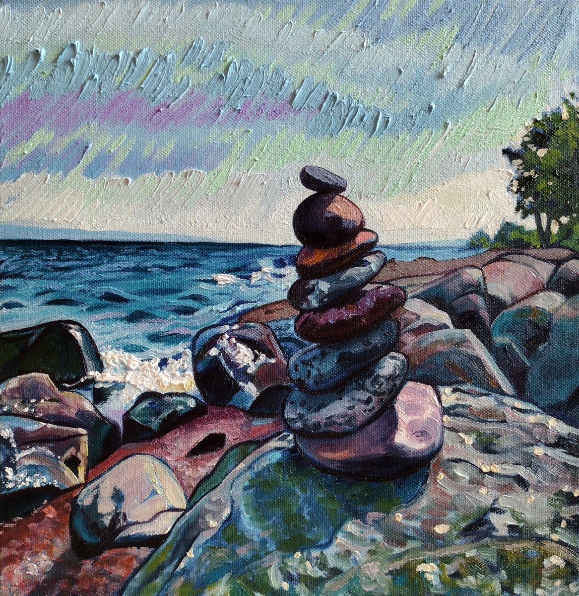 Finding My Way by Heather Friedli  Image: Superior shores awash in stones, reds, blues, greens, yellows. Solid foundations for cairn stones. One on top each other leads the way. Waves crashing in the distance.