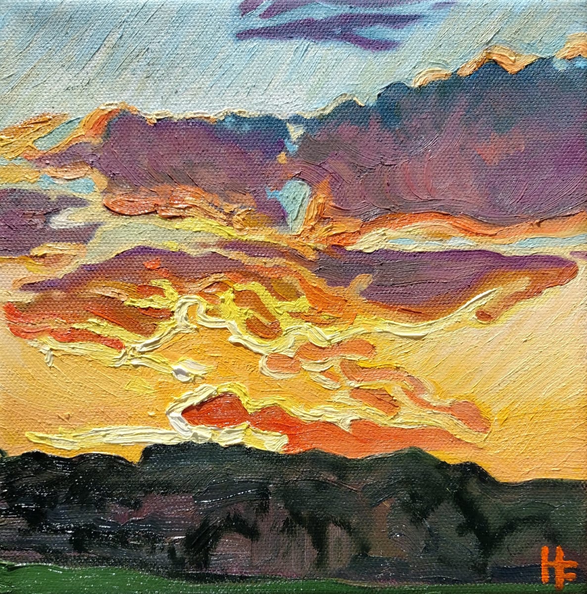 Country Sunset by Heather Friedli  Image: Golden sun drifts below the horizon, casting gentle warm light, setting clouds aglow in yellows and oranges. Shadows of the night sink into purple blue clouds and shadowed undulating landscape below.