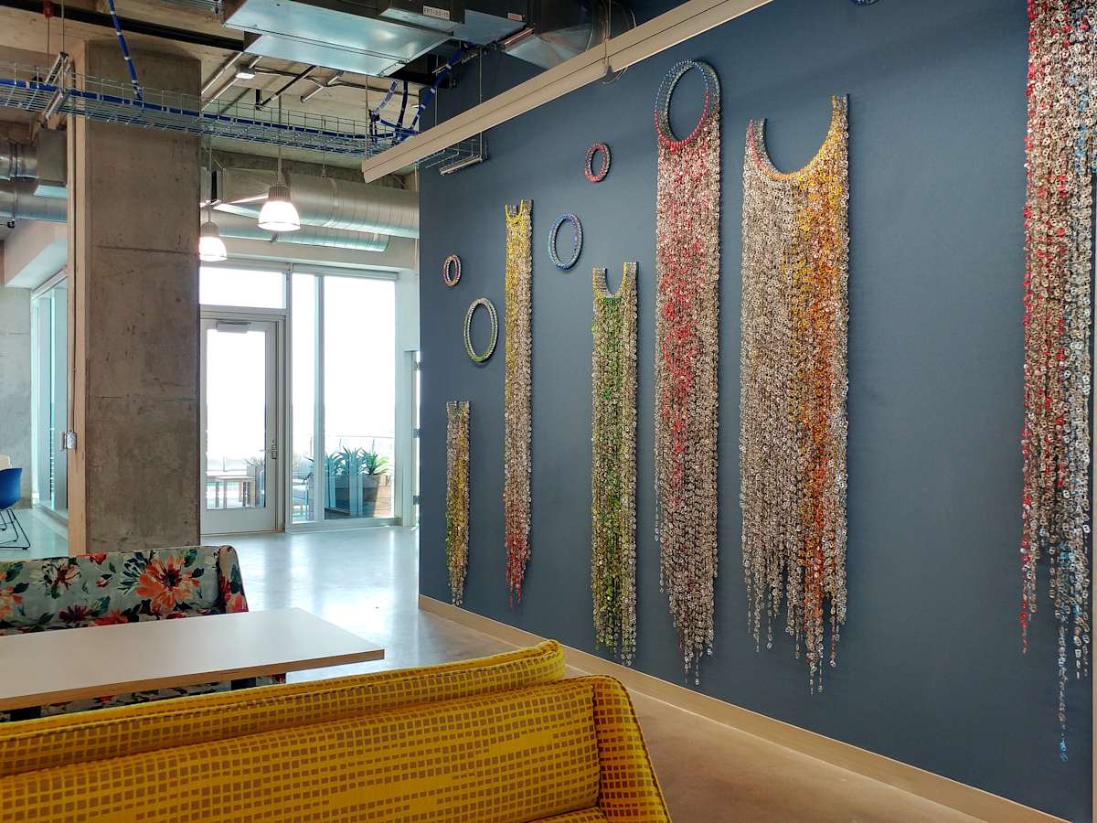 Sparkle Notion by Virginia Fleck  Image: Sparkle Notion is 82 continuous feet of art 
installation covering all the available walls at a Facebook facility with long layered chains 
of can-tabs configured into a “baroque upcycled” aesthetic. This sparkling installation 
playfully incorporated doorways thermostats, ductwork and a stairwell into the overall 
design. Commissioned by Face Book AIR residency (budget 40K