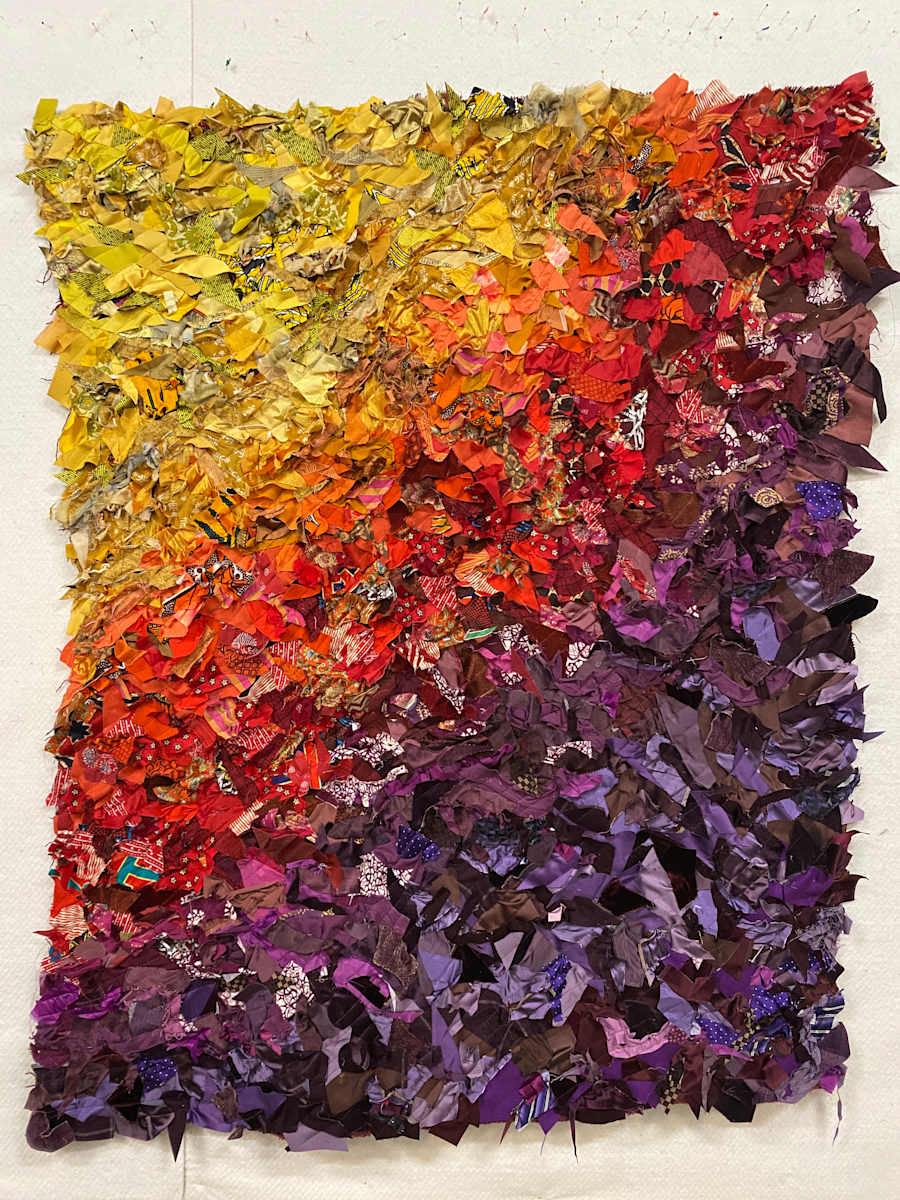 Late Bloomer by Liberty Worth  Image: I have become more and more interested in the scraps that are left behind after I finish a quilted project. I had a major breakthrough in 2024 when I began to separate my scraps into color bins - suddenly the fabric scraps began to look to me like paint - I could use them in ways that felt more like abstract painting. As I have played more and more in this new technique, I have challenged myself - "Can I travel from this color to that color, using only the pieces of scraps that I have on hand?" They also can be installed straight or crinkled.