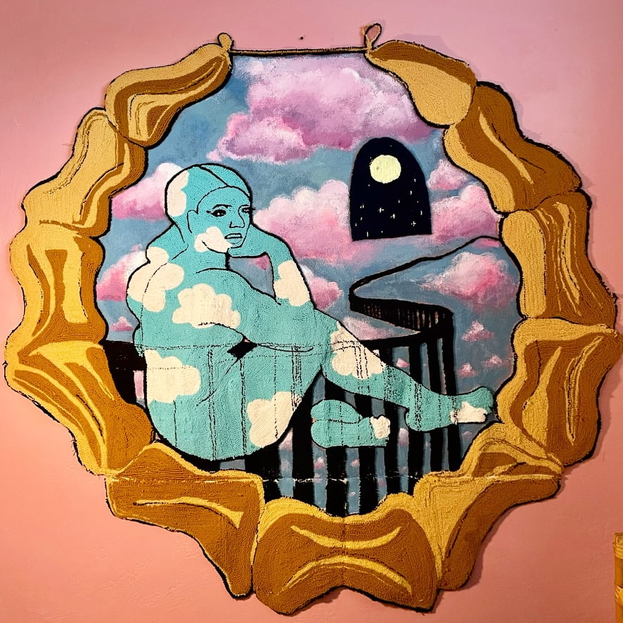 Cloud woman by Katie Ruiz  Image: This painting is a self portrait as sky and clouds transcending the border. The hoop earring references Chicano culture and is also a sit in for a rococo style frame. The represents BIPOC people infiltrating the art world after a long history of racism and sexism.  The portals are safe pathways to cross the border. I thought of the portals when I was thinking of ways to reimagine welcome at the US/Mexico border. 