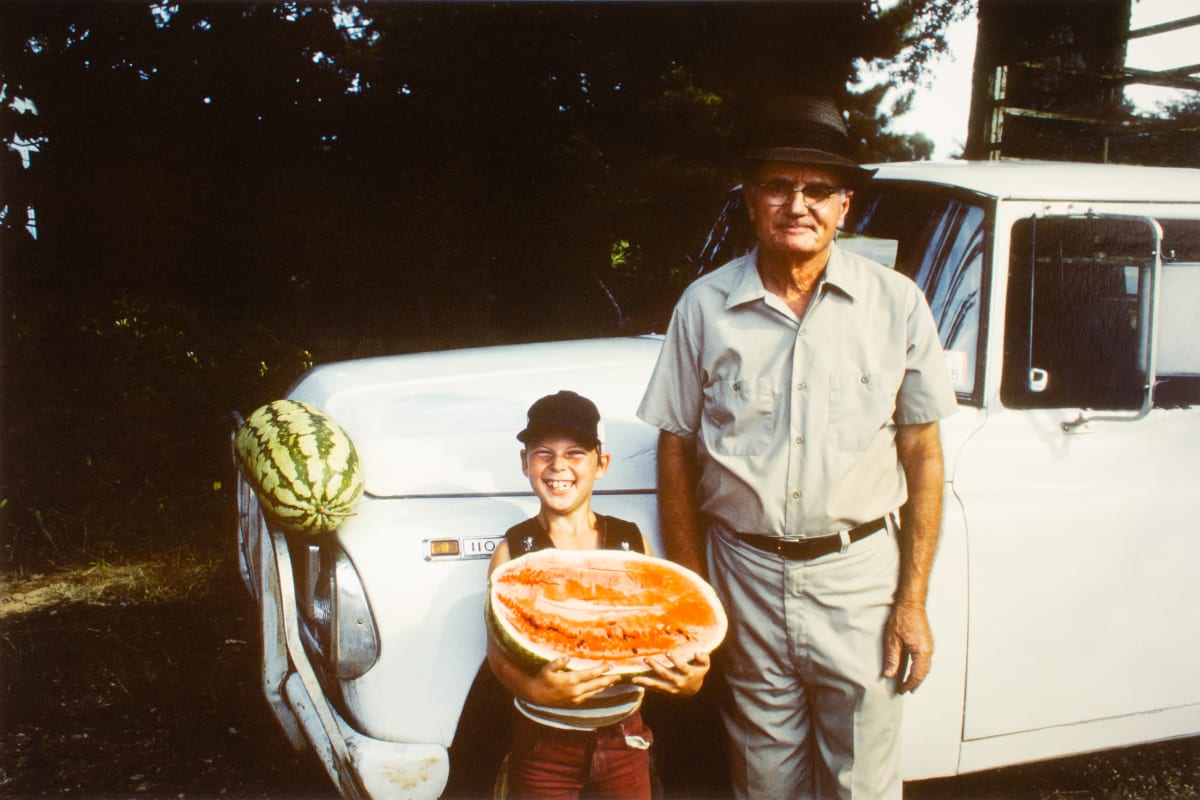 Unidentified watermelon vendor and son, Betcheimer Store, Highway 27, Utica, Mississippi by William R. Ferris 