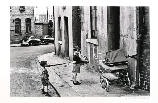 Two Curious Boys, a Cabbage, and a Pram by Alen MacWeeney 