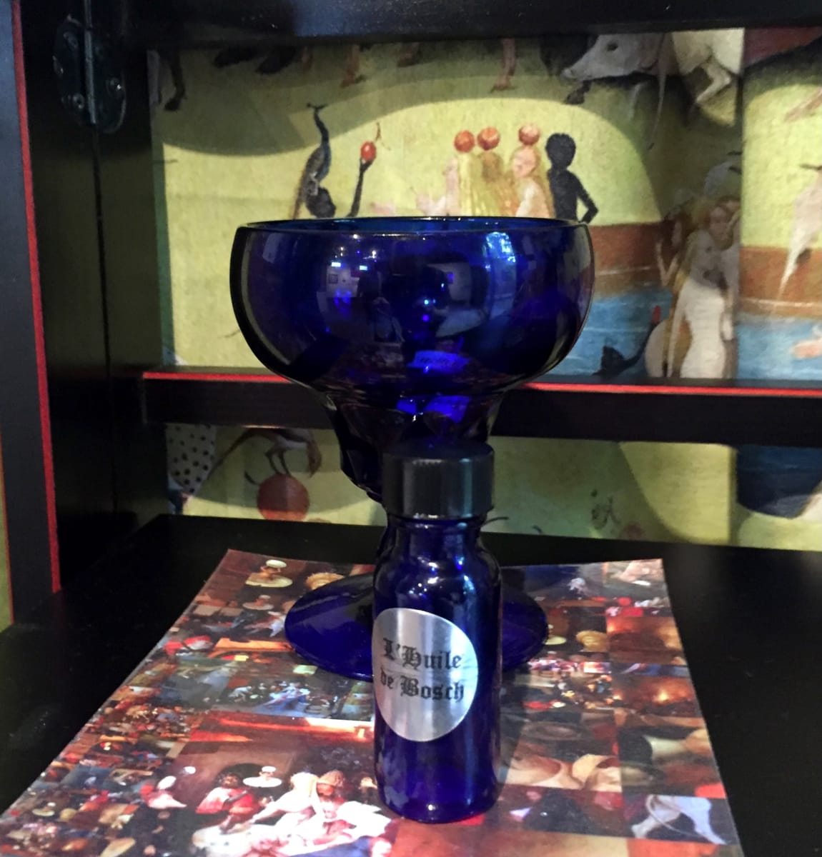 The Garden of Unearthly Delights -- Fragrances (Limited Edition) by Pat Borow  Image: L'Huile de Bosch (fragrance, in bottle),  Printed material by Lisa Tuttle; Installation backdrop by Patty Nelson Merrifield