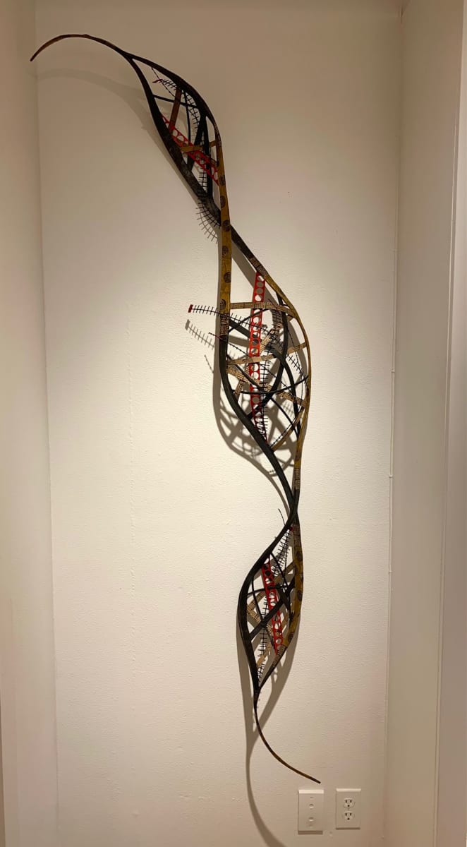 Surprise Twist by Danielle Bodine  Image: Random weave - rattan, cane, Mulberry paper, painted, collaged with prints, painted red plastic tape with holes and plastic fencing 