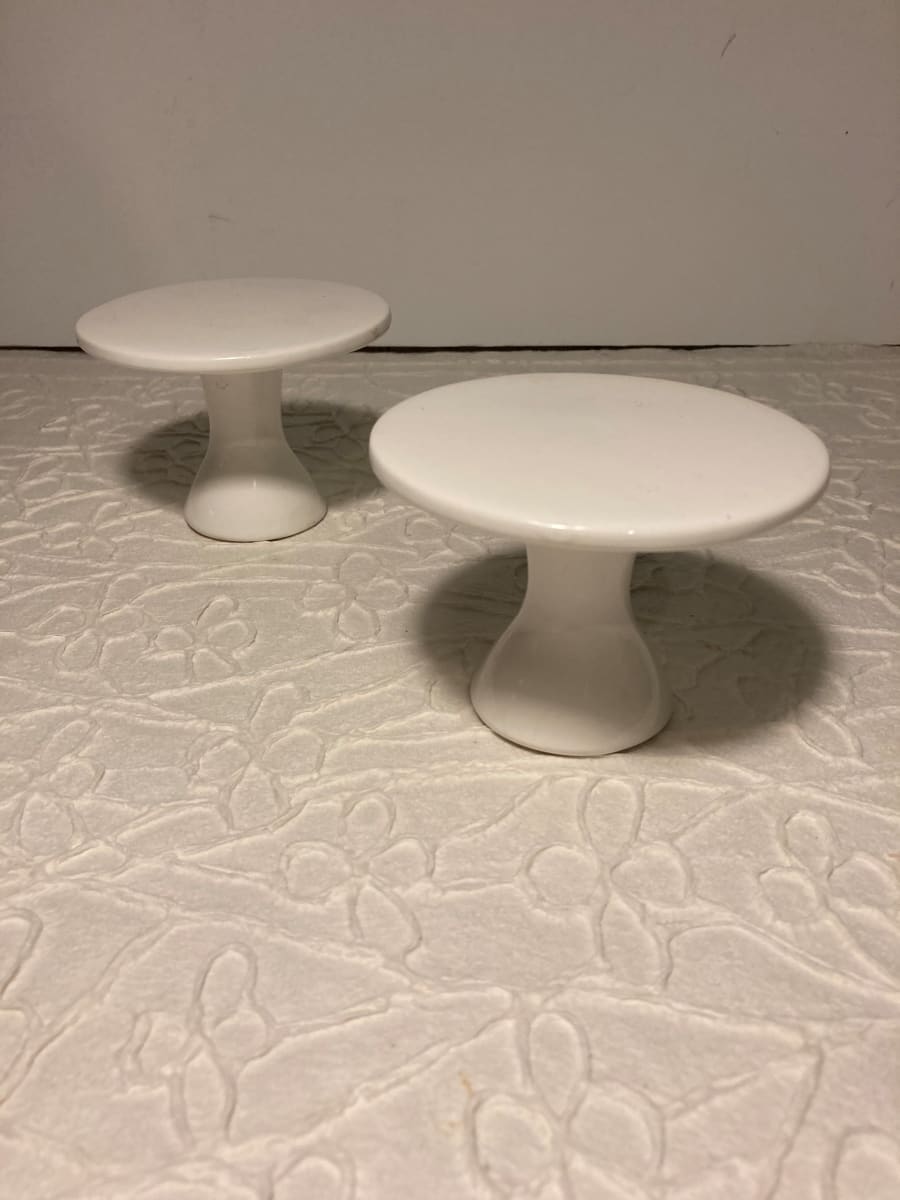 pair of small white pottery stands 