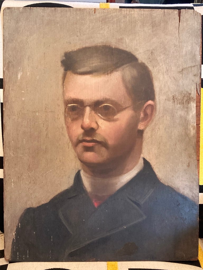 Framed painting on board of man with glasses 