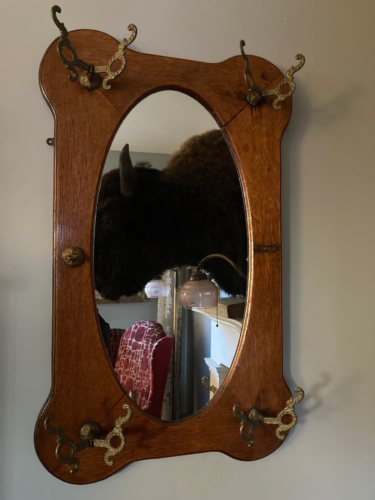 Turn of the century oak mirror with hooks from the collection of