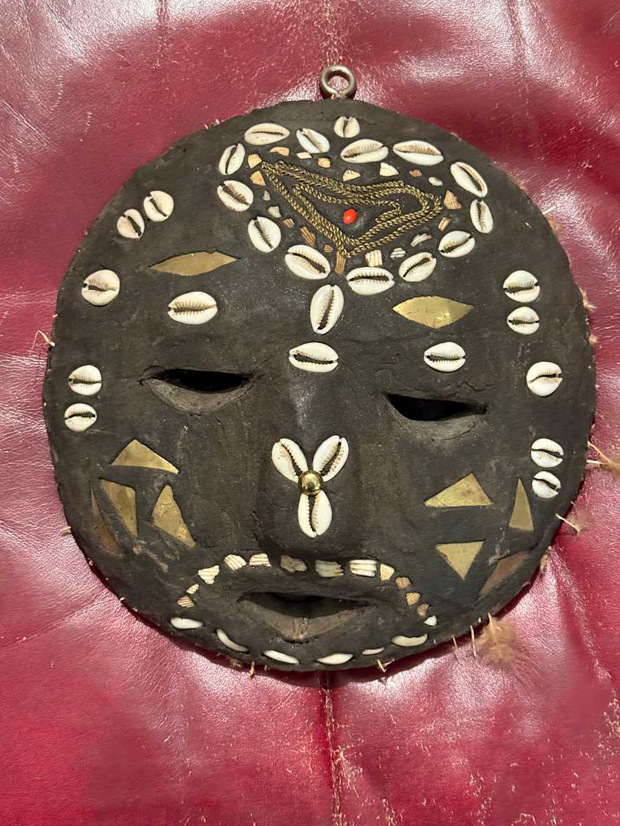 Carved mask with shells 