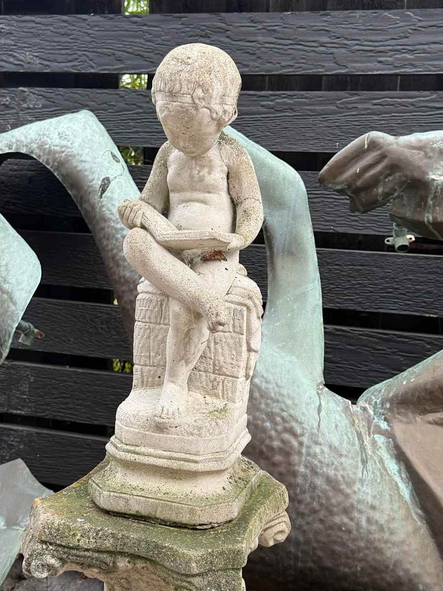 Garden cement boy reading a book, Image 1.