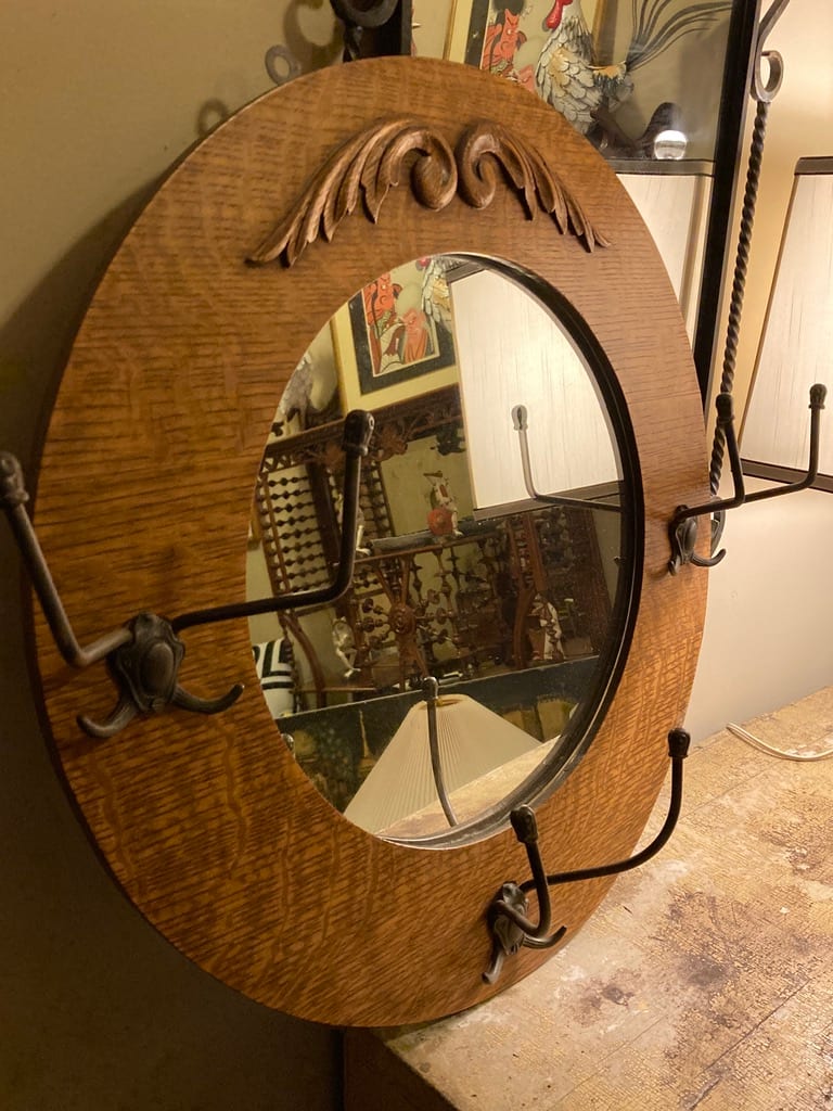 Turn of the century round oak mirror with hooks 