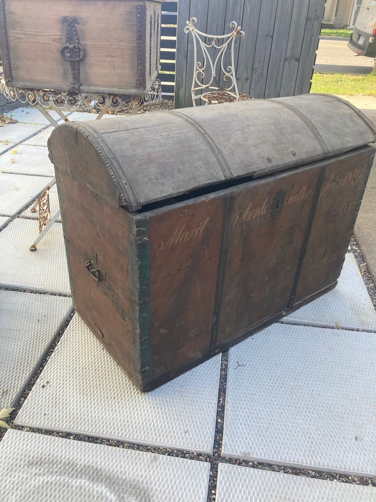 Large domed carved and strapped pine trunk 