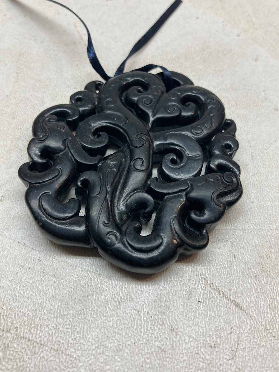 carved double soapstone serpent pendant 