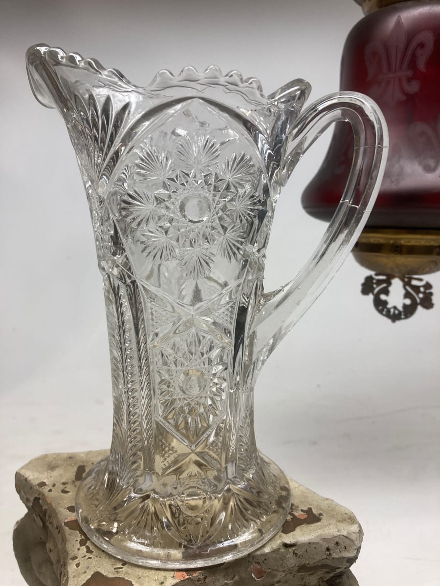 Ornate clear glass water pitcher 