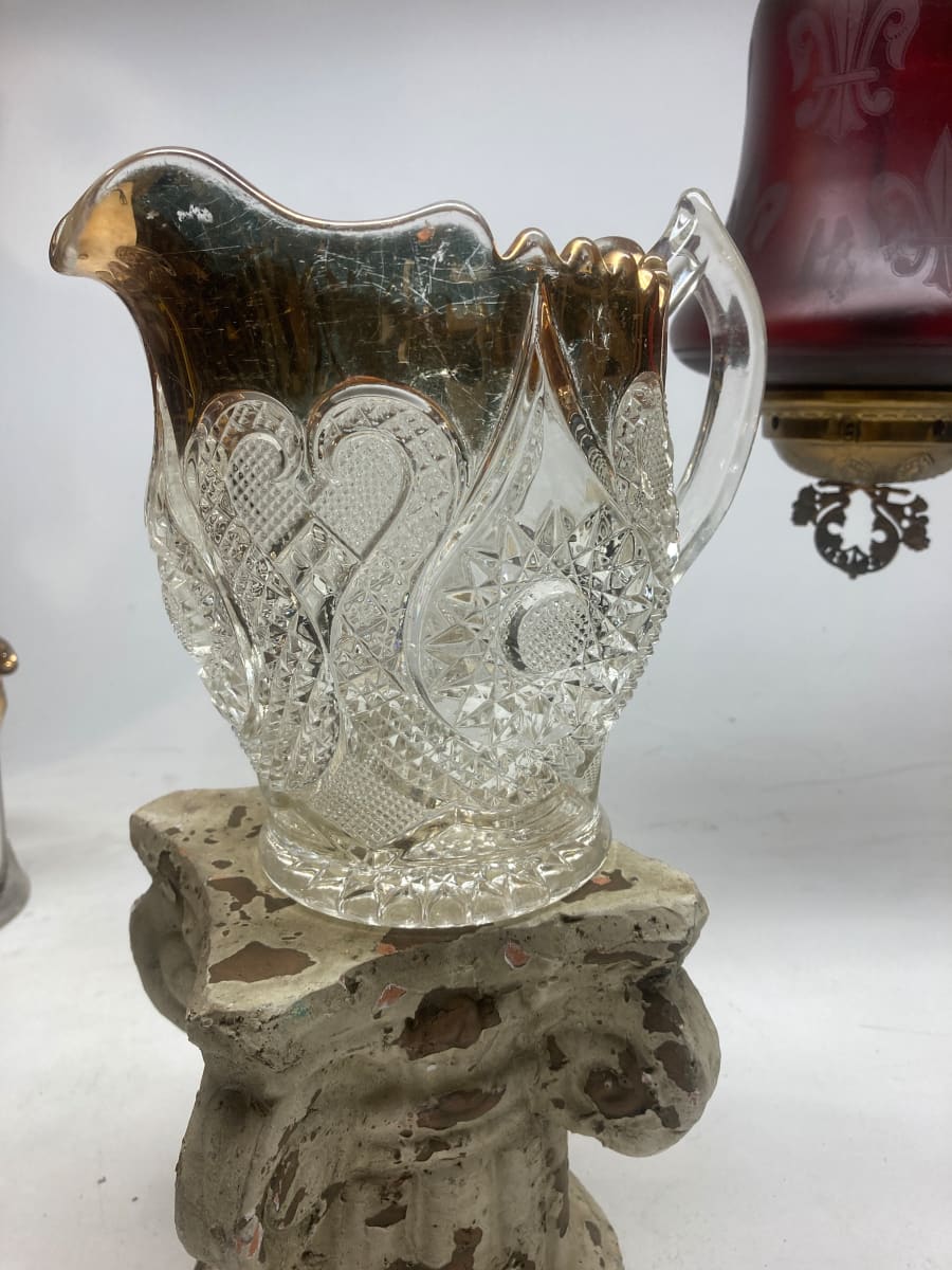 Early ornate water pitcher with gold rim 