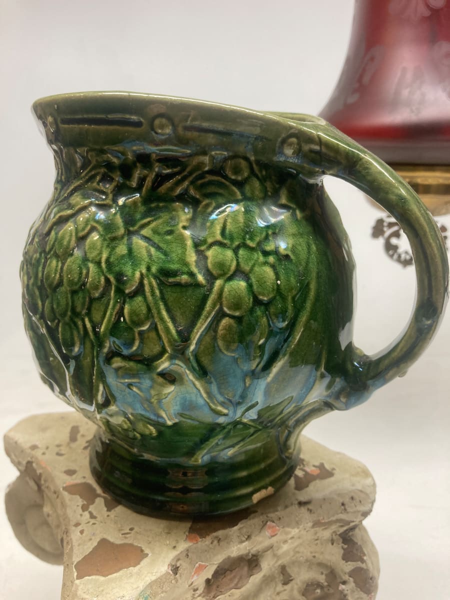 green pottery pitcher with grape pattern 