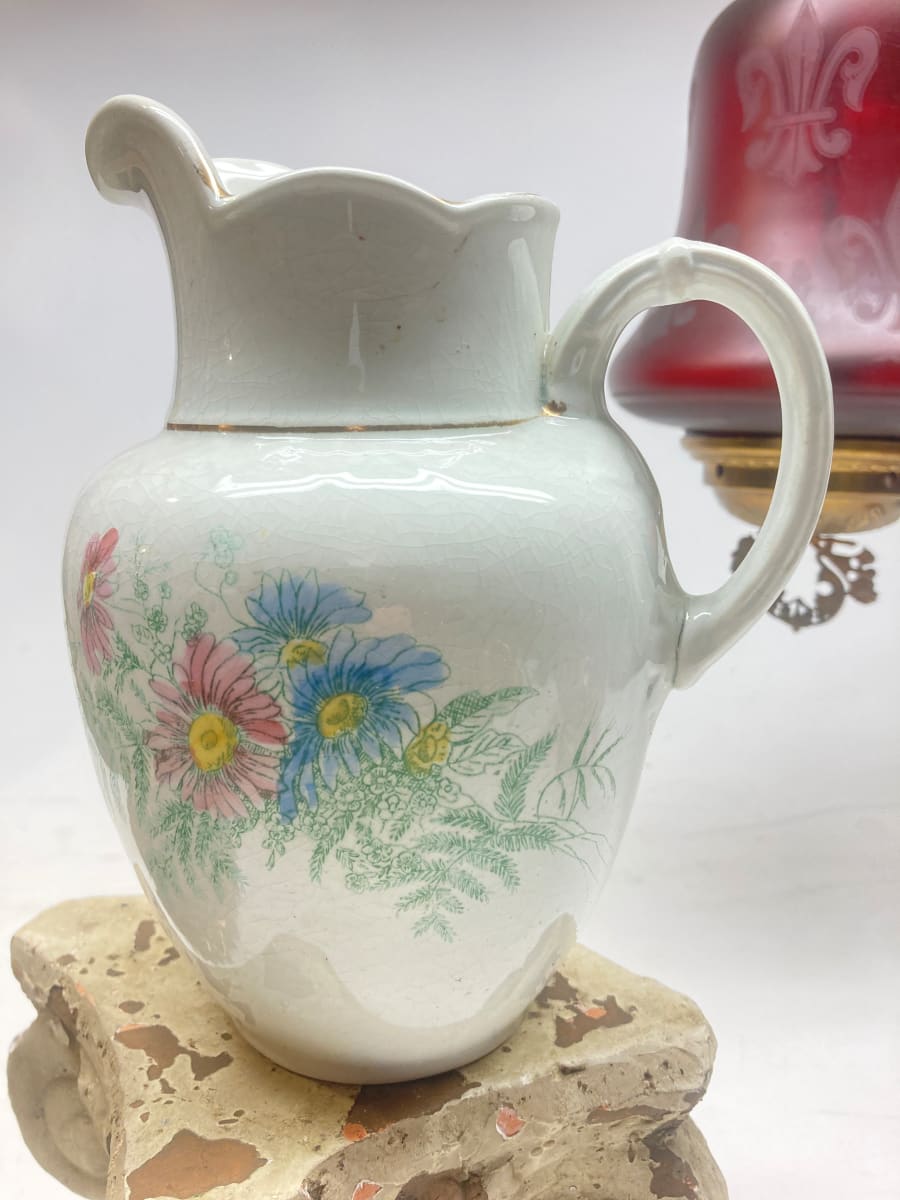 white pottery water pitcher with flowers 