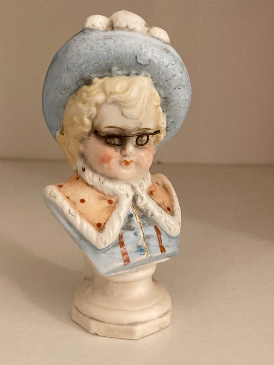 small bisque figure with glasses 