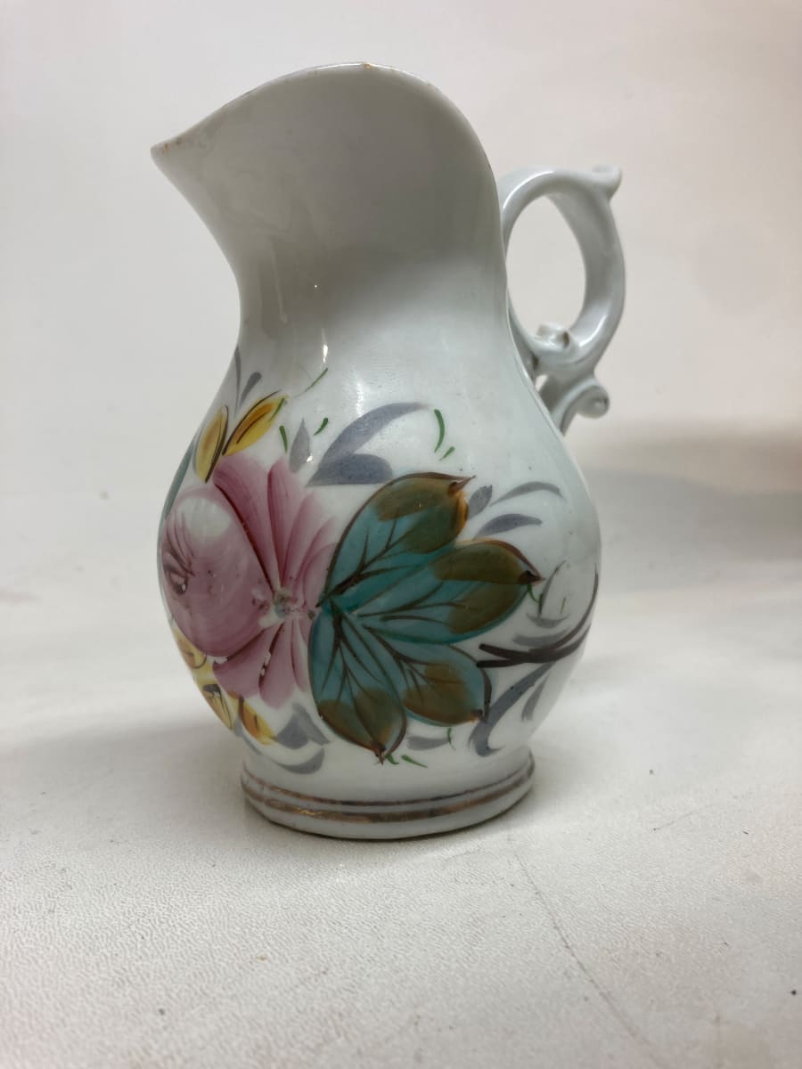 small porcelain pitcher with hand decorated flower 