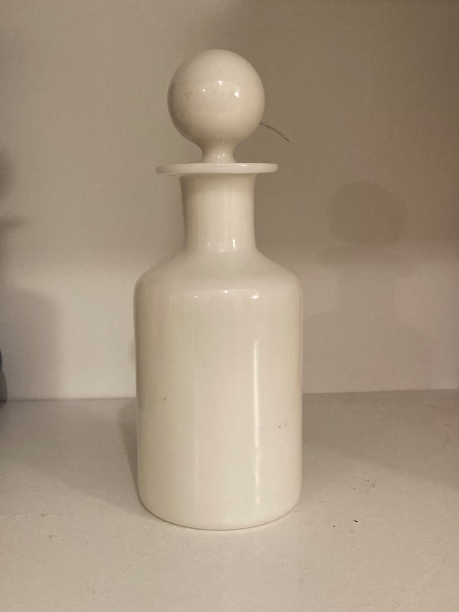 white  milk glass bottle with stopper 