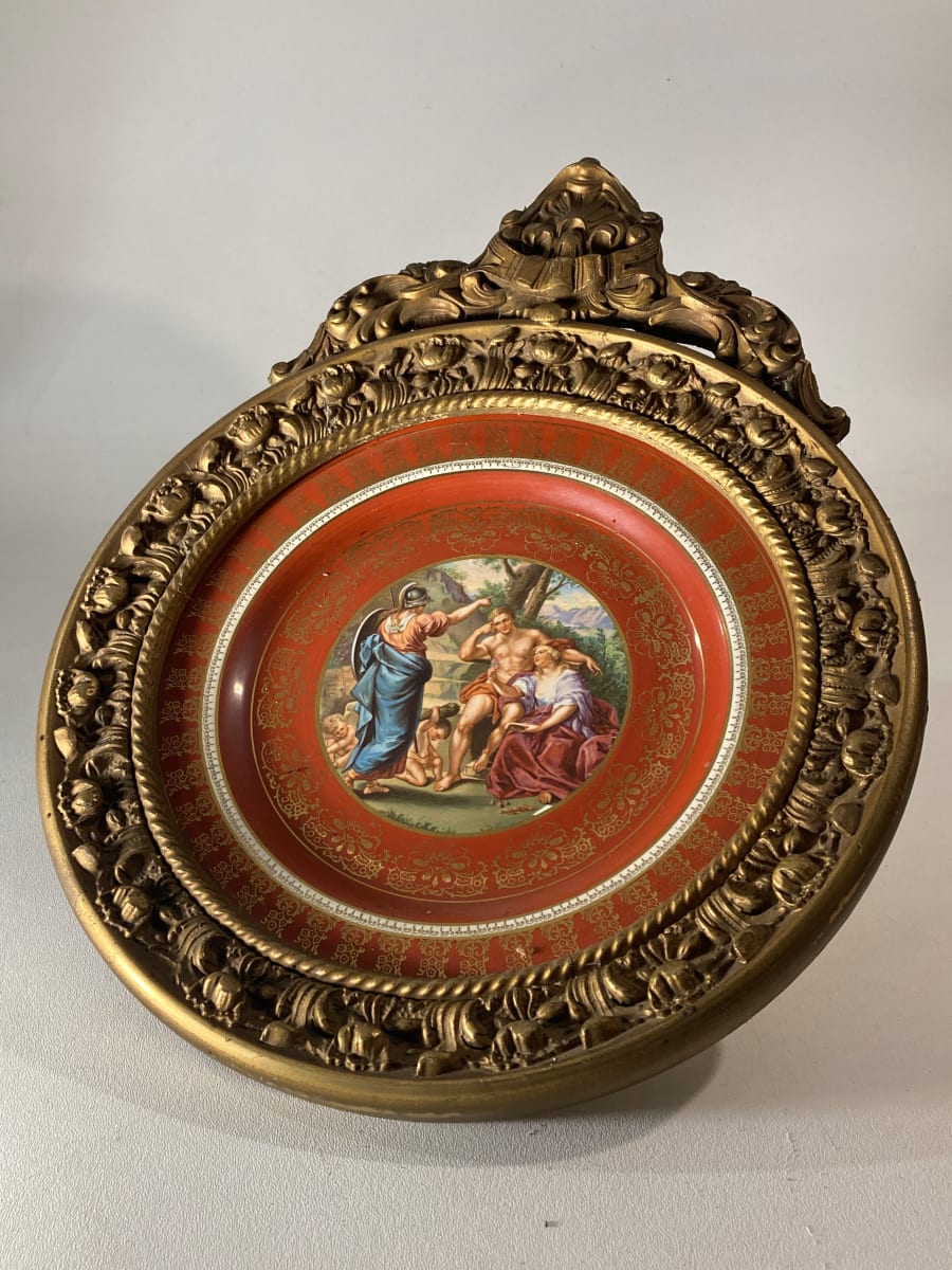 decorated plate in round ornate frame 