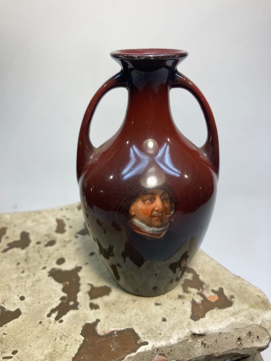 Small two handled pottery vase with portrait 