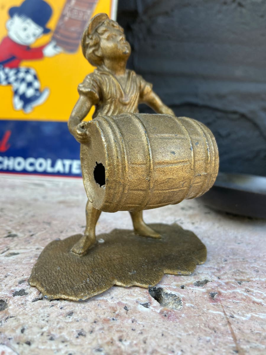 turn of the century boy with barrel metal figure 