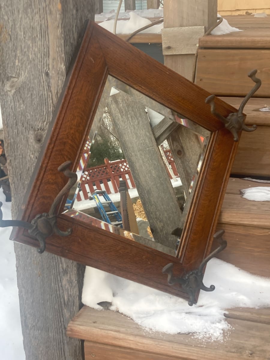 turn of the century oval mirror with hooks 