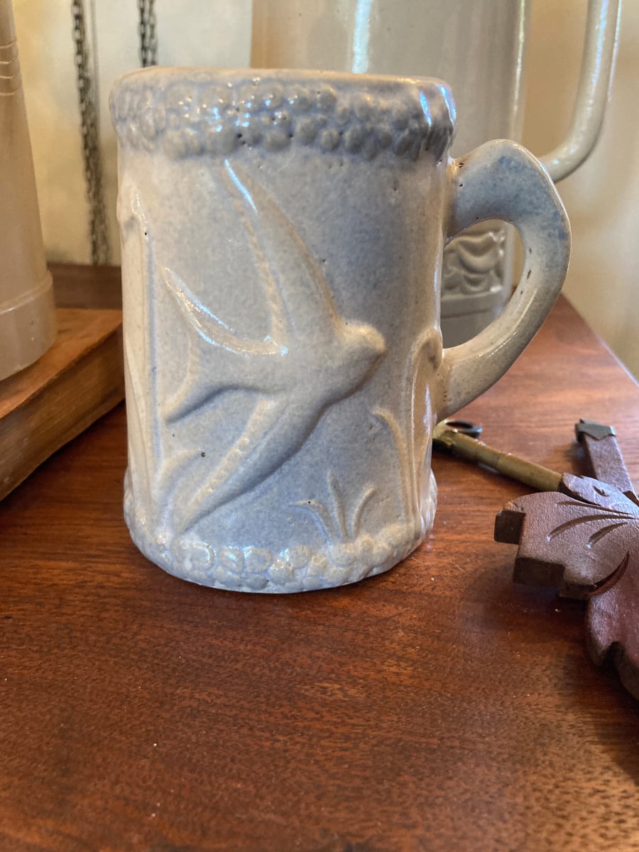 blue and white pottery mug with birds 