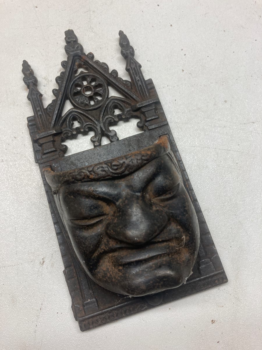 turn of the century metal grumpy wall mounted match holder 