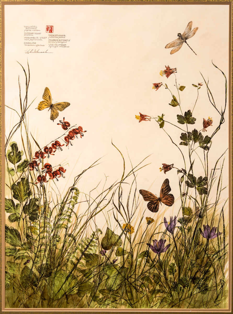 Spring Garden by Vickie Schumacher  Image: “I hope this nature print, in which actual plants and insects were inked then pressed into a surface to create a transferred image, evokes a feeling of soft spring breezes in South Dakota. When all the pieces are inked and printed onto the paper, they are hand-colored, usually with an acrylic wash. You will find bleeding heart, violet, dandelion, pasqueflower, wild columbine, a swallowtail butterfly, and a monarch. As in my other nature prints, this piece was printed using oil-based ink, with a color wash of acrylic paint added afterwards. The paper is stained to give the illusion of an aged botanical print.”