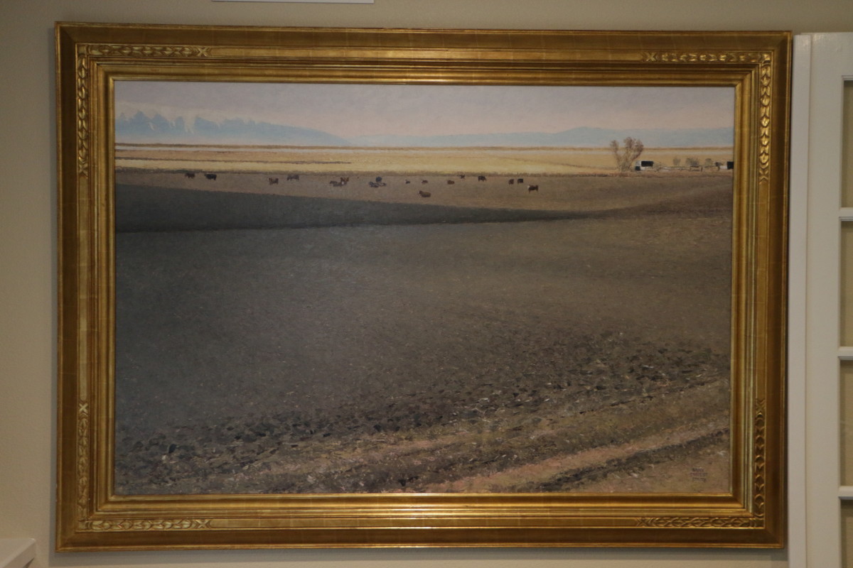 Between Seasons by Smith   Image: Large, horizontal landscape painting of the fallow field, cattle in the distant sunlight with a high horizon.