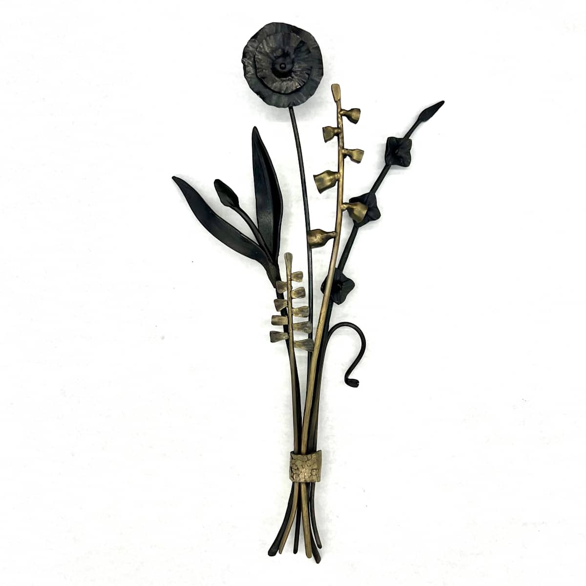 Penland Gathering by Susan Madacsi  Image: This botanical work was created at Penland during a workshop I taught last year. I used both sheet and architectural steel to forge the organic shapes, riffing and playing with form of the collected flora of the campus. 