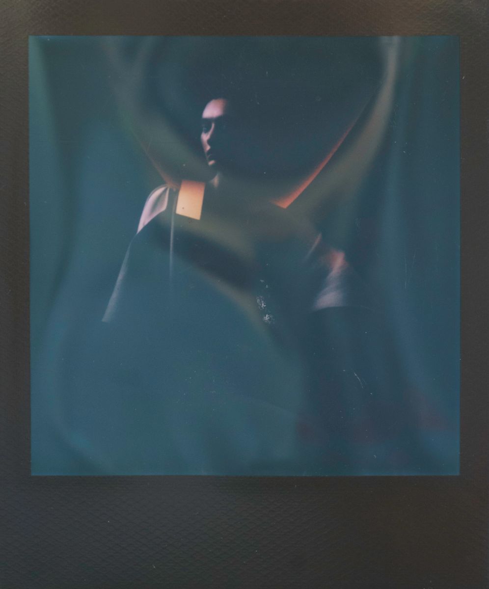 Afterimage Oracle / Recall Error by Maria Lankina  Image: A frontal figure flickers against a pale field, as if half remembered, with small distortions that feel like memory glitches rather than camera errors.