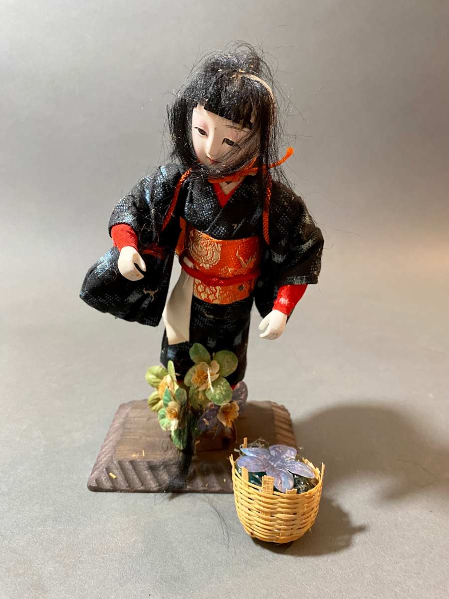 Doll with basket and flowers 