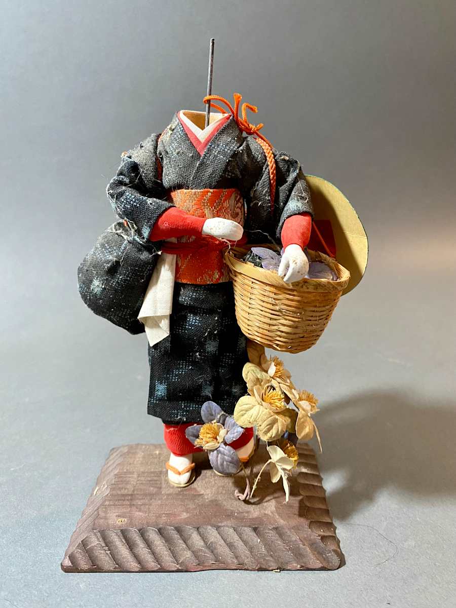 Doll with basket and flowers 