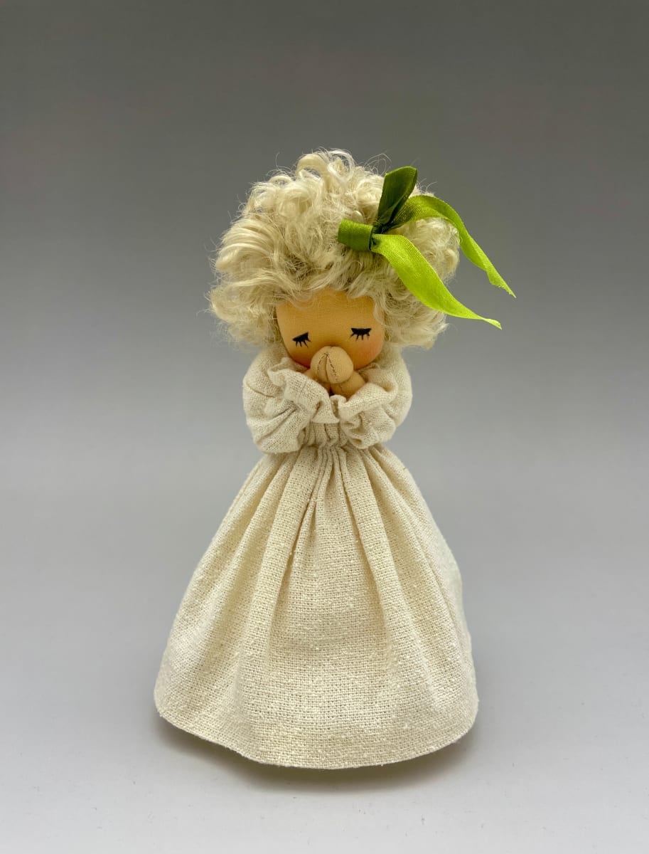 Little Prayer 1 by Moonyoung Jeong  Image: The praying child is expressed as a simple stuffing doll.
The artist's sign is written on the bottom of the doll