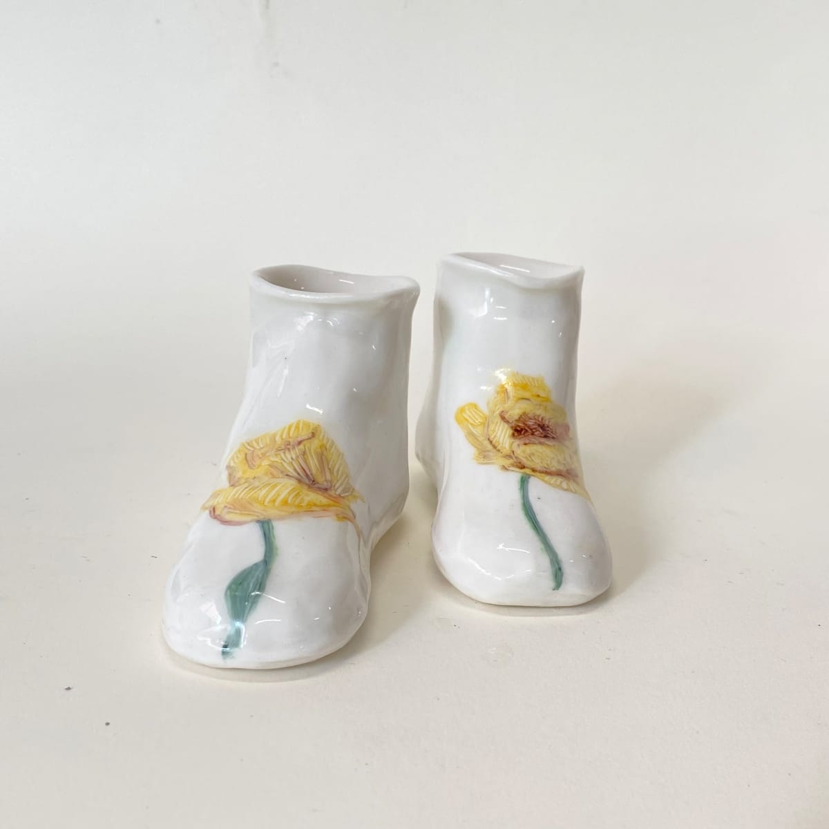 Yellow Poppies by annekwasner@gmail.com  Image: A pair of slip cast porcelain shoes, flowers hand painted with on-glaze.