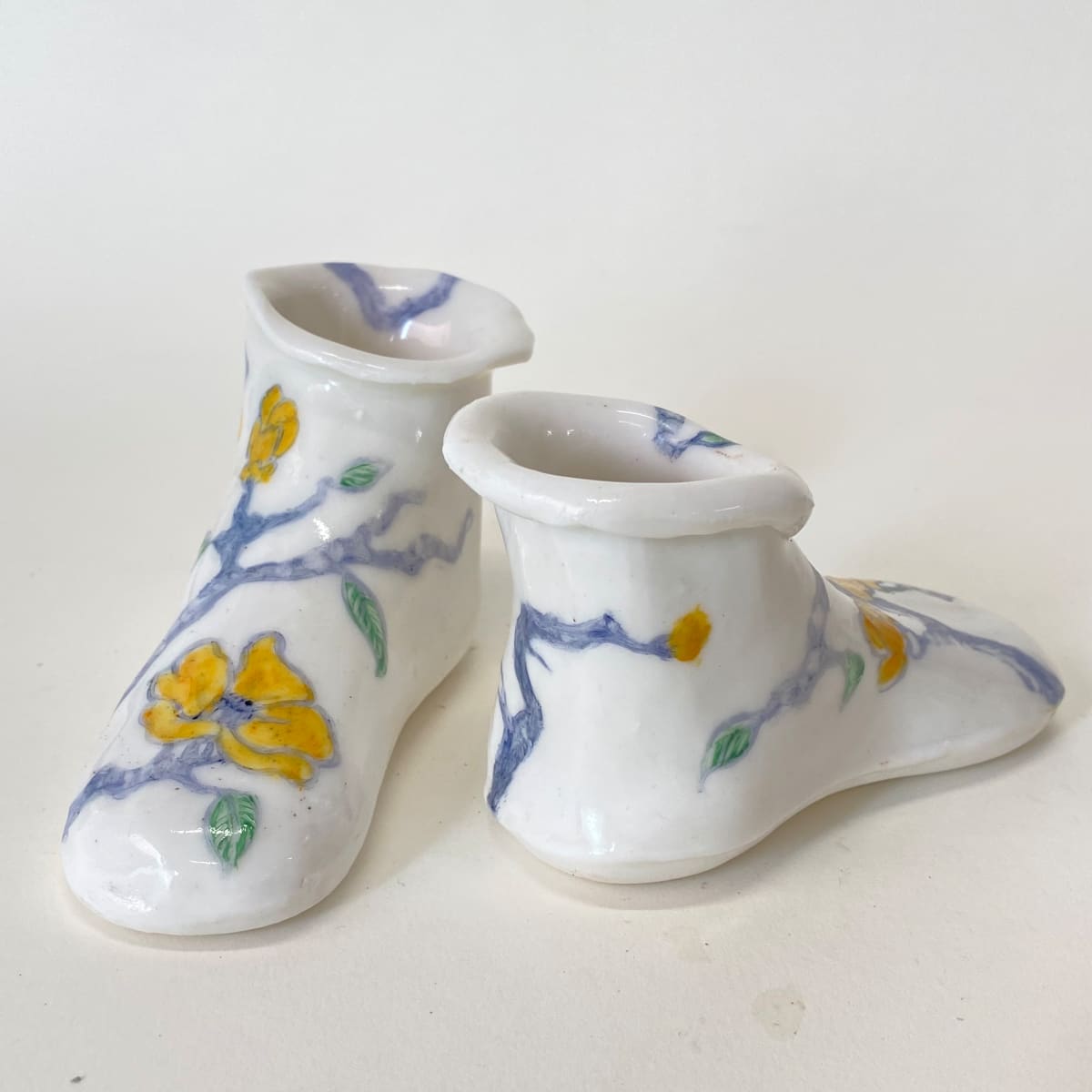 Yellow Flowers On Twisted Branches by annekwasner@gmail.com  Image: A pair of slip cast porcelain shoes, flowers hand painted with on-glaze.