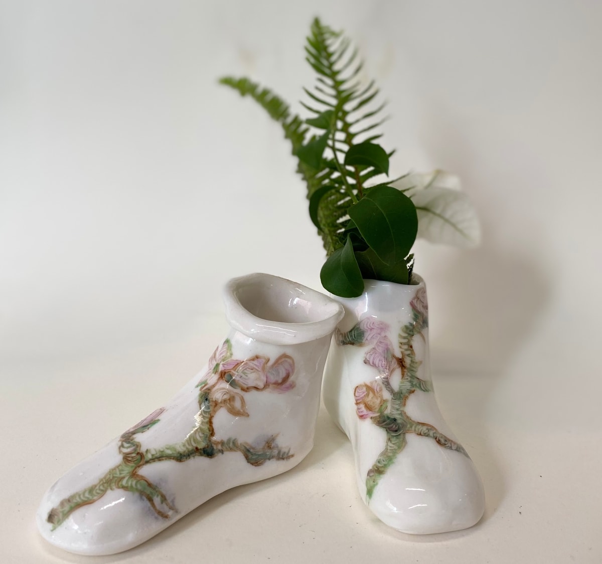 Pink Flowers on Green Branches. by annekwasner@gmail.com  Image: A pair of slip cast porcelain shoes, flowers hand painted with on-glaze.