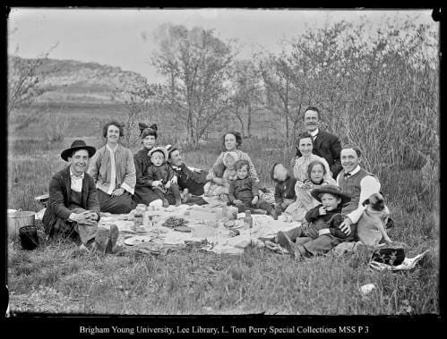 [Family Picnic in Coalville Park] by George Beard  Image: Multiple families picnic in the grass.