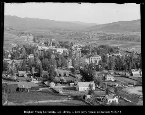 [Coalville as seen from Cemetery Hill, Beard's Opera House in left foreground (Marsh is now Echo Dam)] by George Beard  Image: Looking down onto a city in a valley.