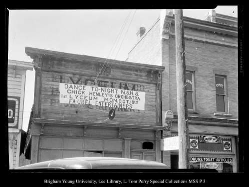 [Storefronts in Coalville] by George Beard  Image: Sign announcing Dance Tonight N.S.H.S. Chick Henley's Orchestra 1st Lyceum Mon Oct. 18th Faubel Entertainers.