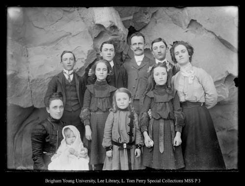 [George Beard Family up Chalk Creek above Coalville; Back: Arthur, Howard George, Edgar, Ethel; Front: Lovenia, Paul, Gladys, Glenn, and Edna] by George Beard  Image: Family portrait in front of a rock.