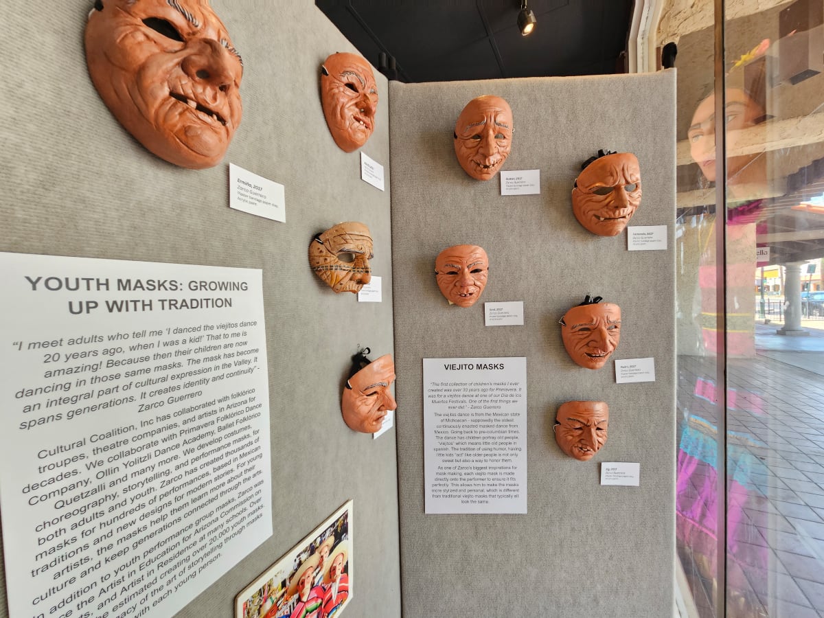 Viejito masks on display at pop-up exhibit.