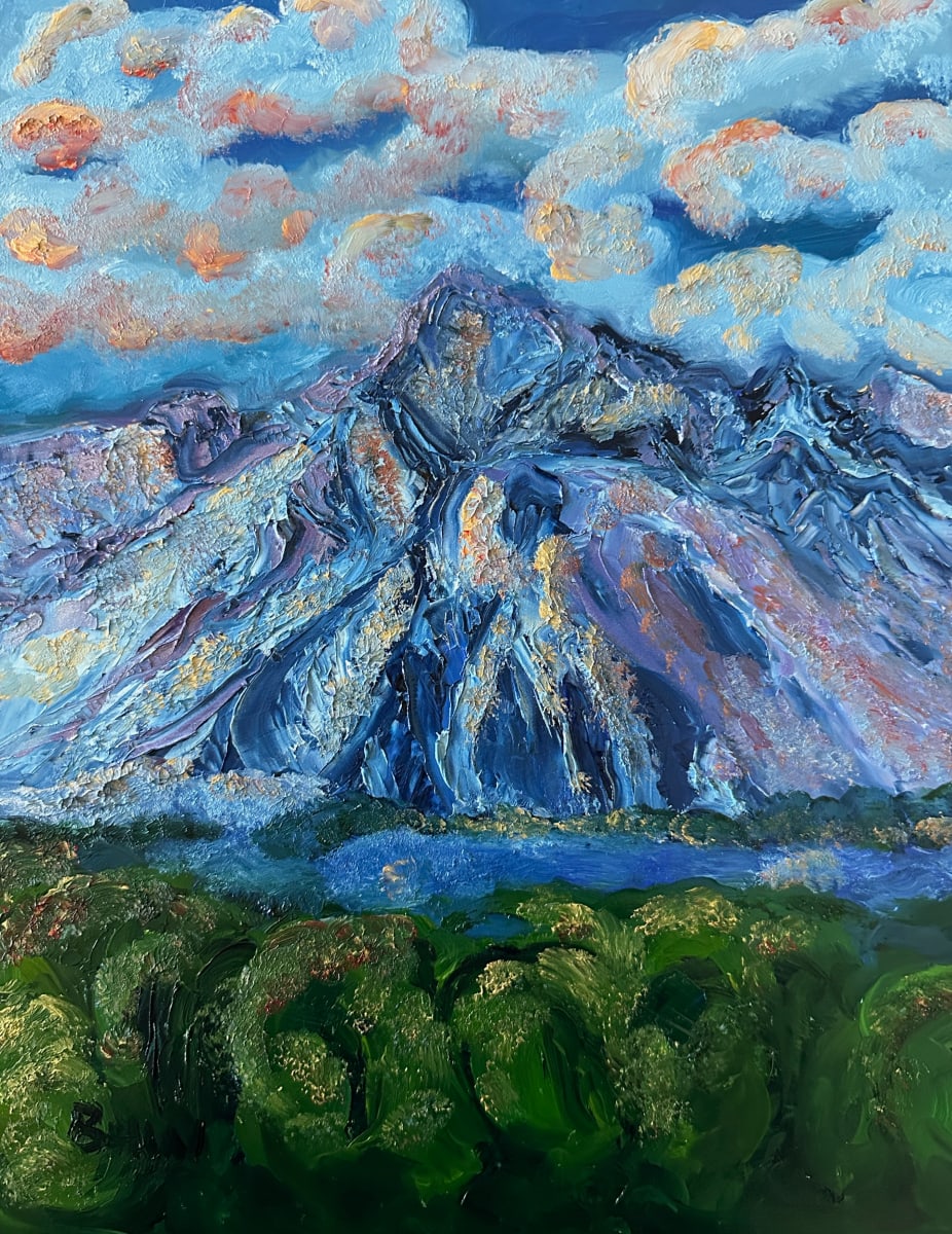 Out Back by Brian Hugh Wagner  Image: Vivid blue and pink hues dominate the sky, while a large mountain takes center stage with its dramatically textured peaks. The foreground features a lush green forest,, adding a sense of depth to the landscape.