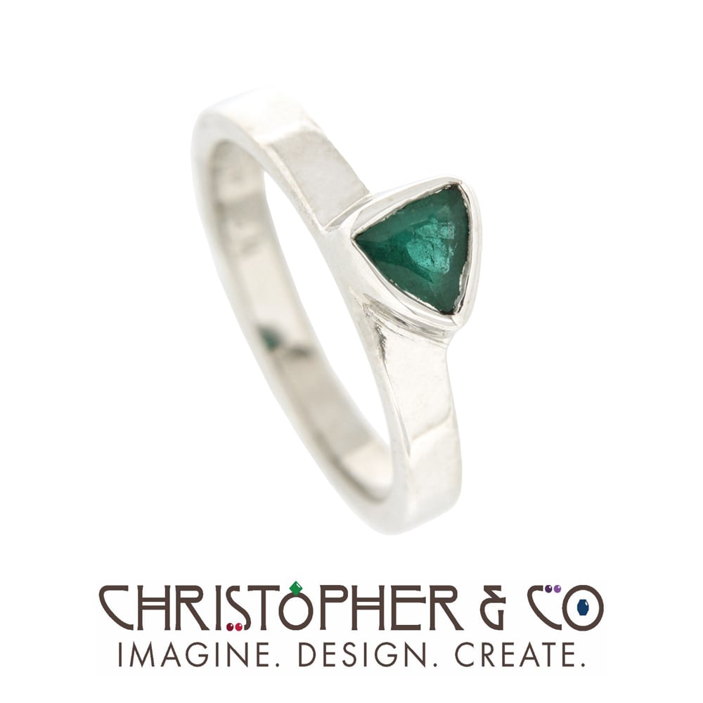 CMJ A 21132   White gold ring designed by Christopher M. Jupp set with trillion cut emerald.  Image: CMJ A 21132   White gold ring designed by Christopher M. Jupp set with trillion cut emerald.