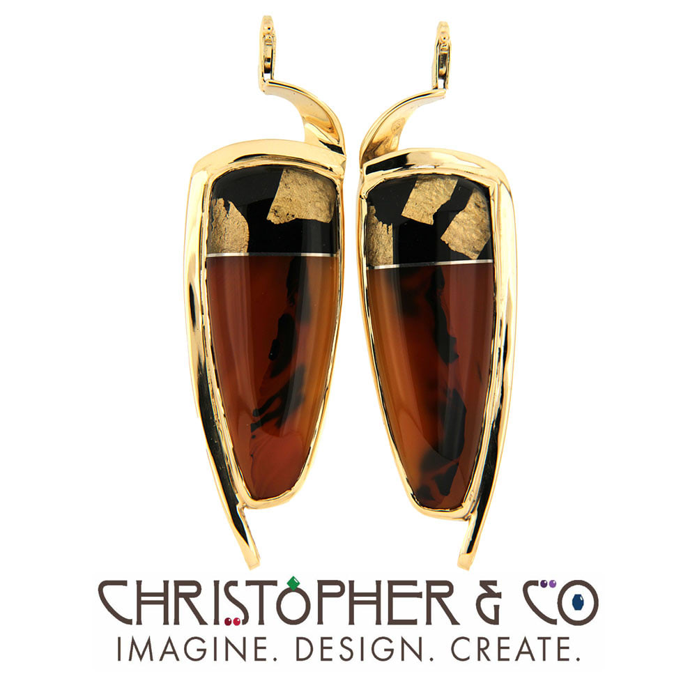 CMJ A 21163  Gold Element Pair set with handcarved gemstone composite by Steve Walters designed by Christopher M. Jupp.  Image: CMJ A 21163  Gold Element Pair set with handcarved gemstone composite by Steve Walters designed by Christopher M. Jupp.  Steve Walter's Gem is onyx, agate, titanium and mother of pearl.