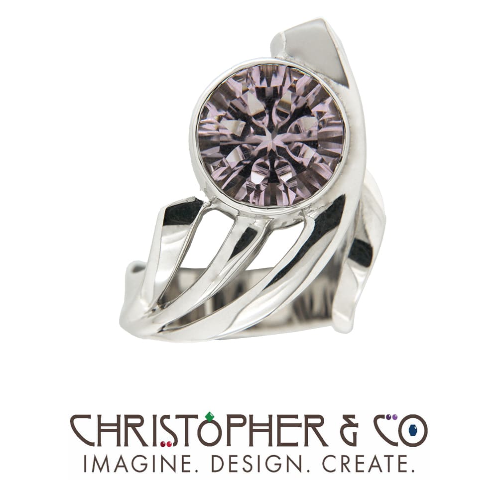 CMJ D 21080 White Gold Ring designed by Christopher M. Jupp set with concave cut amethyst cut by Richard Homer.  Image: CMJ D 21080 White Gold Ring designed by Christopher M. Jupp set with concave cut amethyst cut by Richard Homer.